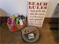 Beach rules sign, wicker bag w/water shoes