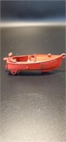 Antique red cast iron speed boat with man