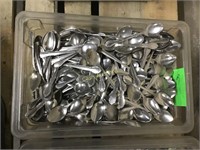 Bin  of assorted spoons
