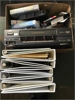 Binders, Vhs Player, Two Boxes