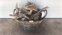 Basket of assorted seashells and drift wood