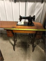 Singer sewing machine in cabinet. Electric.