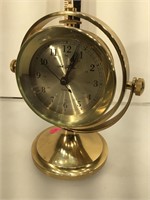SettThomas brass quartz clock, on gimballed brass