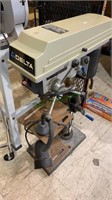 Delta brand drill press with an attached light,