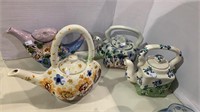 Four Russian porcelain tea pots, with the lids