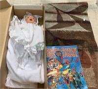 Wall tapestry with a baby doll dressed in the box