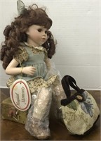 MAGICAL MOMENTS PORCELAIN DOLL SITTING ON SUITCASE