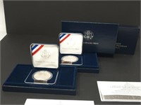 Pair of proof silver dollar coins with COA