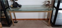 Glass top sofa table with shallow shelf. Top is