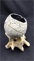 Modern ceramic pot on bone stand