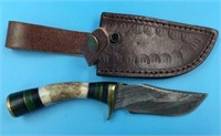 Damascus bladed knife with brass guard and end cap