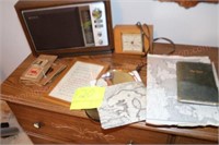 Clock, radio, mouse house trap, travel log book,