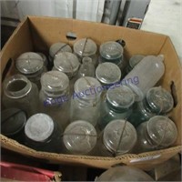 Box of banded canning jars, mostly clear