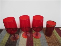 Four ruby colored drinking glasses
