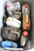 Tub of assorted partial oil jugs