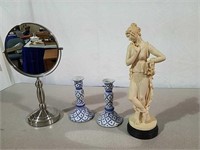 Candlesticks, magnifier mirror and woman