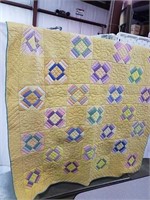 Vintage yellow quilt with off-white backing and