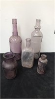 5 purple glass bottles