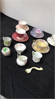 5 tea cups and saucers with mini tea cups
