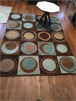 Total of three rugs and small iron table. Large