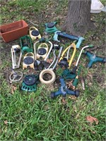 Assortment of sprinklers and one clay pot.