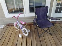 Child's bicycle with training wheels, chair, and
