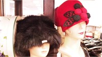 Two women's hats: one is natural fur and one