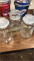 3 assorted glass canisters with lids