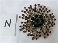 2 1/2" costume star burst brooch with red stones