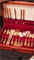 62 pieces of goldtone flatware with bamboo
