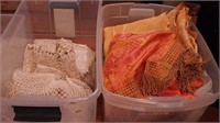 Two containers of vintage linens: doilies,