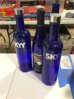 4 blue wine / liquor bottles