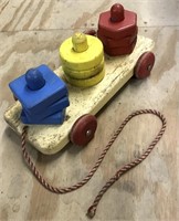 Toddler pull toy. Primary colors shapes on pegs