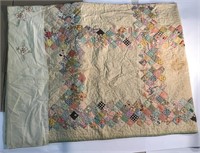 hand stitched quilt with embroidered head border