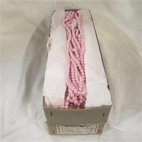 Two boxes of pink AB 6mm plastic pearls. Each box