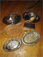 lot of silver looking trays and platters