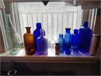 lot of coloured bottles and jars