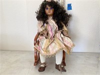 Porcelain Doll in rocking chair