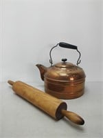 copper tea pot and vintage rolling pin