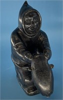 Signed black soapstone carving of a native holding