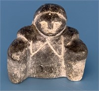 Crude soapstone carving of a native, 2" across