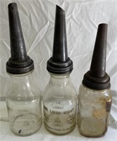 Two vintage oil bottles, one mason jar,  with oil