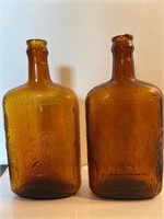 2 amber glass spiderweb whiskey bottles