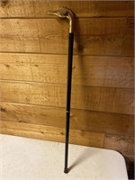 Cane with brass duck head handle
