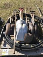 Pallet of various shovels, hay forks, water hose