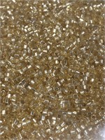 Toho 15/0 hex seed bead. Silver lined light gold.