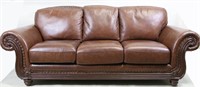 BROWN LEATHER THREE CUSHION SOFA