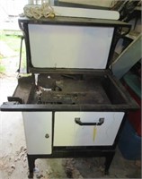 Antique cast metal stove with back splash. Note: