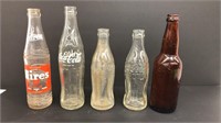Vintage glass Coca Cola bottles and pop bottles.