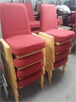 8 red wood framed stacking chairs